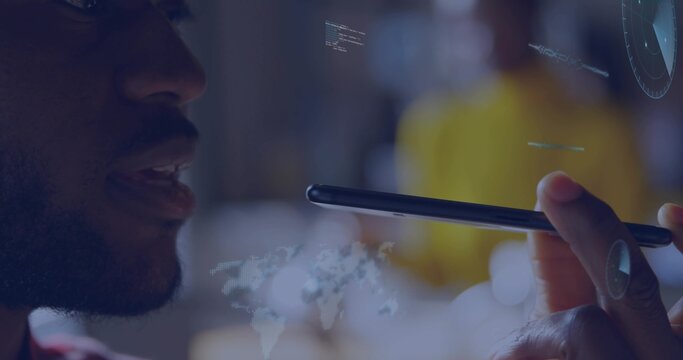 Speaking man with glasses wearing red top holding smartphone near mouth in dim cafe, AR overlays