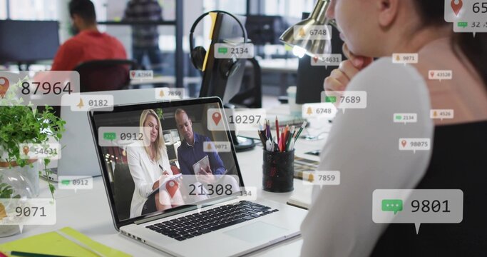 Showing laptop with two colleagues on call in office, woman wearing black top, notifications - Powered by Adobe