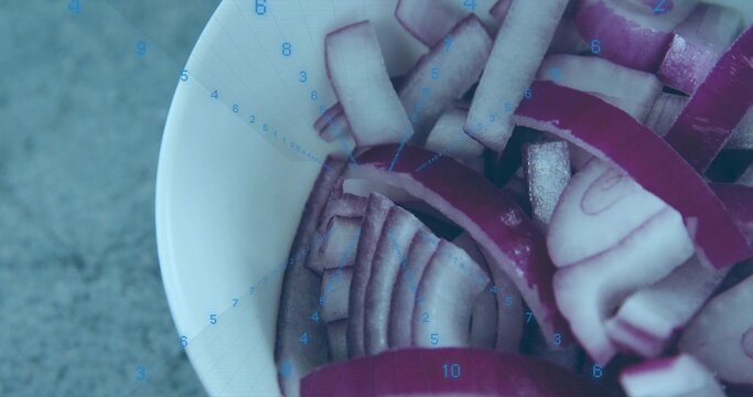 Showing white ceramic bowl holding sliced purple onions on grey counter, blue timer overlay ticking