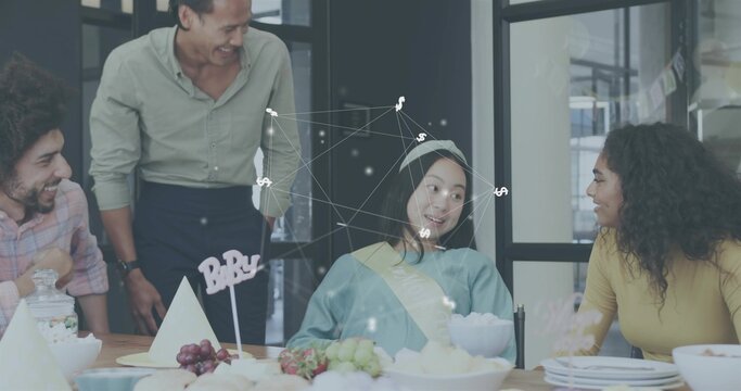 Smiling team gathering seated woman wearing blue top, sash, paper hat in meeting room, BABY sign - Powered by Adobe