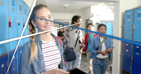 Standing blonde teen in striped tee denim jacket holding tablet in school hallway with blue lockers