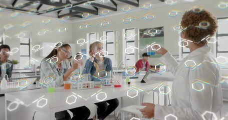 Showing instructor in lab holding vial and dish at right bench, wearing lab coat, copy space