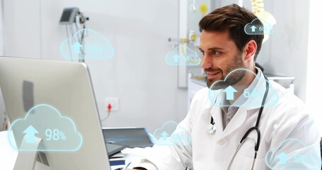 Analyzing male physician in lab coat checking monitor at clinic with stethoscope, cloud graphics