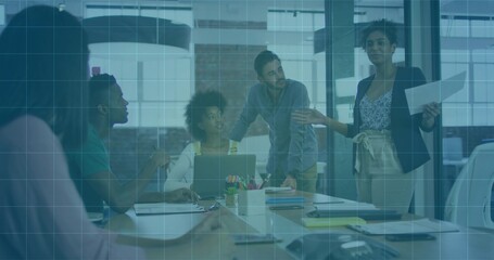 Leading presenter in dark blazer and team discussing plan at office with laptops blue grid overlay