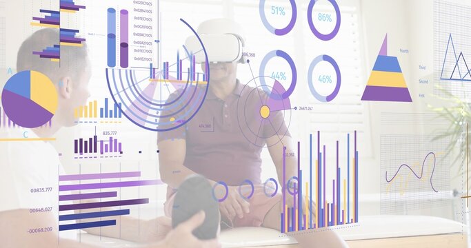 Testing man wearing white virtual reality headset and maroon polo viewing AR data charts in lounge