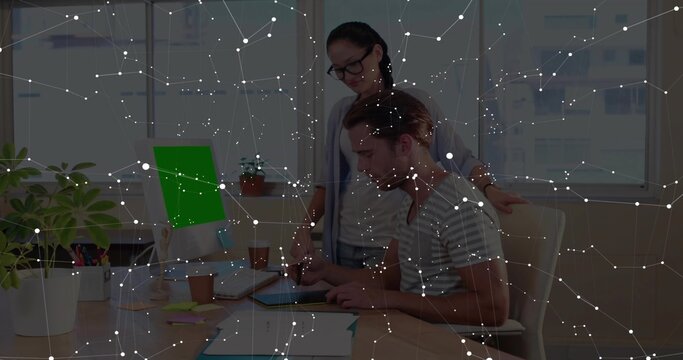 Working duo man striped shirt tapping tablet as woman cardigan watching bright office green screen