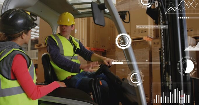 Gesturing forklift driver and coworker wearing hivis vests and hard hats in warehouse, using HUD
