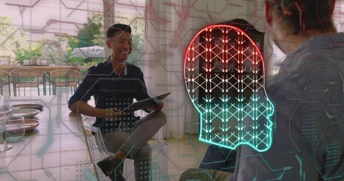 Presenting Asian man in dark shirt on acrylic chair at cafe, holding tablet with hologram head