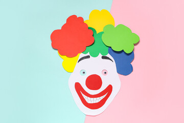 Paper clown's face on color background