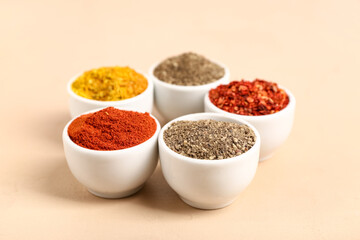Composition with bowls of fresh aromatic spices on color background