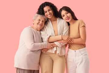 Beautiful women smiling on pink background. Women's History Month
