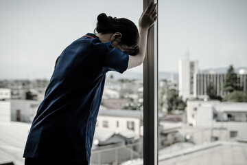 Doctors, nurses, medical staff and female technicians knocking on hospital windows in frustration
