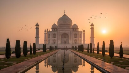 Obraz premium Taj Mahal at Sunrise with Soft Golden Light, Symmetric Reflection Pool and Silhouette Birds Above Iconic Monument in Agra India
