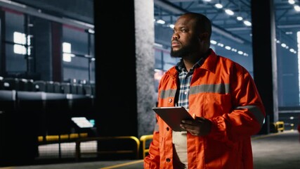 Worker uses technology tools to coordinate construction and fabrication tasks, showing manpower, industrial engineering and the power required for consistent manufacturing operation. Camera B.