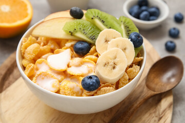 Healthy cereal bowl with yogurt and fresh fruits on grey background, closeup