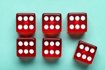 Red game dices on turquoise background