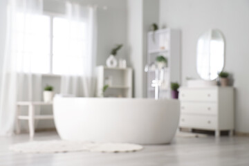 Blurred view of interior of modern white bathroom with pots of lavender flowers
