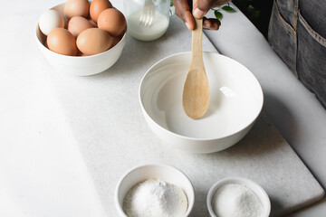 an empty white mixing bowl on a white countertop 