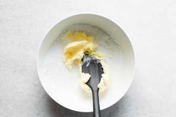 Top view of Creaming butter and sugar with a spatula, the process of making a cake or cookie