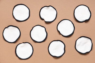 Many reusable cotton pads on brown background