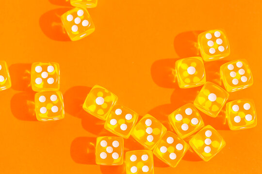 Yellow game dices on orange background