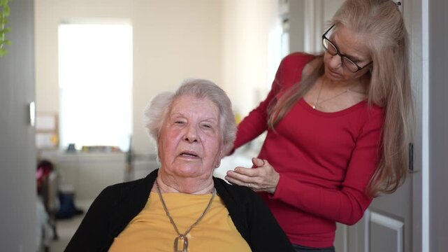 Elderly woman receives gentle care and attention from a staff member at a home healthcare facility, promoting comfort and wellbeing.