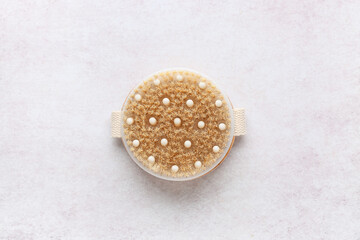 Massage body brush on white background, closeup