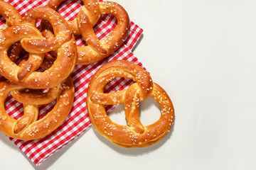 Tasty salted pretzels on grey background
