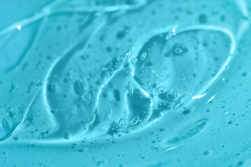 Texture of snail mucin gel on blue background