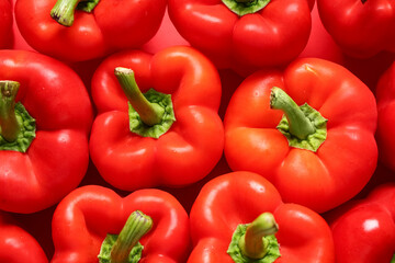 Texture of red bell peppers on color background