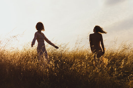Women Dancing in a Field at Magic Hour