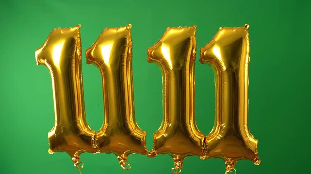 Shiny gold number balloons spelling out 1111 against a vibrant green background