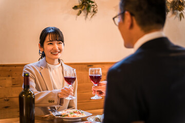 A couple in suits having dinner at a restaurant, colleagues
