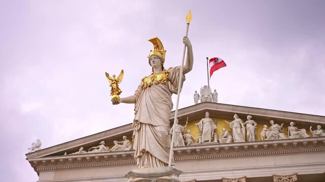 Pallas Athena Fountain statue located in front of the Austrian Parliament Building in Vienna, Austria. Travel destination for tourist visiting Austria. Europe summer tourism.
