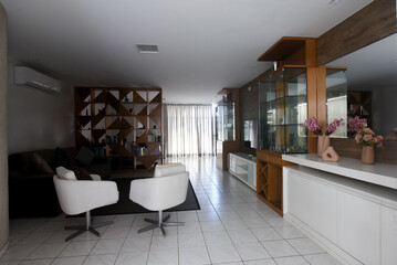 modern living room interior design, white floor and stylish wooden furniture, contemporary residential architecture, spacious apartment lounge area, white design armchairs and natural light