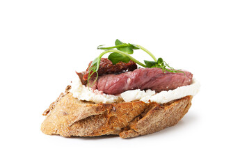 Delicious bruschetta with roast beef, cream cheese, sun-dried tomato and microgreens isolated on white