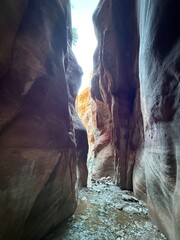 Kanarra Falls hiking trail. Kanarraville, Utah. Gorgeous canyoneering river hike. waterfalls and slot canyons. Next to Kolob Canyon, Zion national park. Ankle to knee deep water. Red rock mountains. 