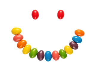 Colorful jelly beans arranged in a happy smiling face against a dark background
