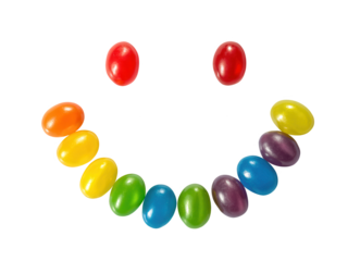 Colorful jelly beans arranged in a happy smiley face on a black background