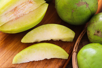 A closeup of fresh Ambarella (Kedondong) fruits, a tangy, crisp tropical fruit. Piled in a woven basket, the fruits is often used unripe in Southeast Asian salads, pickles, and beverages.