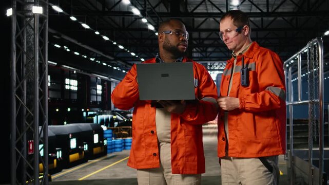 Manufacturing engineers manage fabrication operations with equipment in warehouse, showcasing professional workflow with metal production tools and power within the industry plant. Camera A.