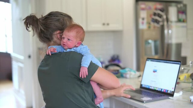 mother multitasks daily, parent juggles household duties with professional responsibilities simultaneously, woman cares for newborn while working on her laptop during everyday busy moments