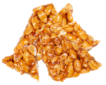 close-up photograph of several jagged pieces of traditional crunchy peanut brittle or georgian gozinaki, featuring whole nuts and caramelized honey syrup.