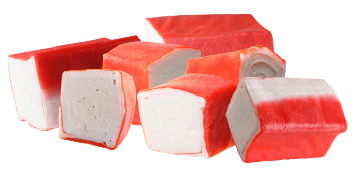 high definition photograph of a collection of bright red and white surimi blocks or imitation crab sticks piled together on a solid black backdrop.