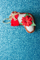 Christmas stocking ornament with poinsettia on glitter background