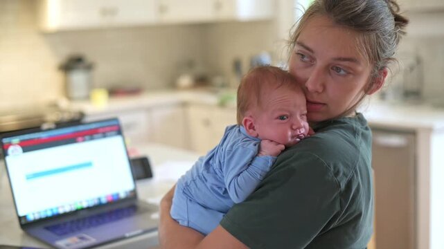 mother watches newborn diligently at home, mother attentively supervises her baby under soft lighting, mother maintains vigilant supervision of her newborn baby in softly lit kitchen