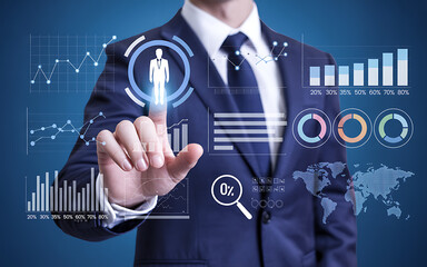 Businessman interacting with futuristic financial data analytics interface finance