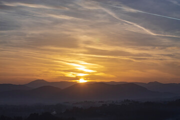 Dreamlike sunset over Bosnian hills outside Sarajevo, vivid tones and minimal horizon for modern design projects.