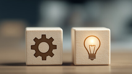 Wooden blocks displaying gear and lightbulb symbols representing problem solving innovation idea creation and the interaction between process and creativity.

