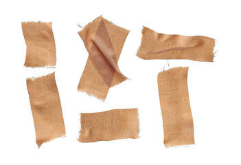 close up photograph of six torn, rustic, flesh-colored woven fabric bandages with frayed edges scattered randomly on a deep transparent background.
